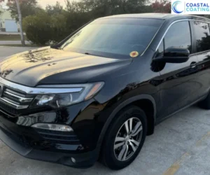 view of a luxury vehicle's hood showing a deep mirror reflection after a professional car detailing service