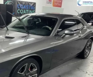 highlighting its glossy finish and tinted windows inside the detailing shop