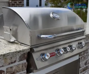 view of a stainless steel built-in gas grill with control knobs mounted on a light brick outdoor counter